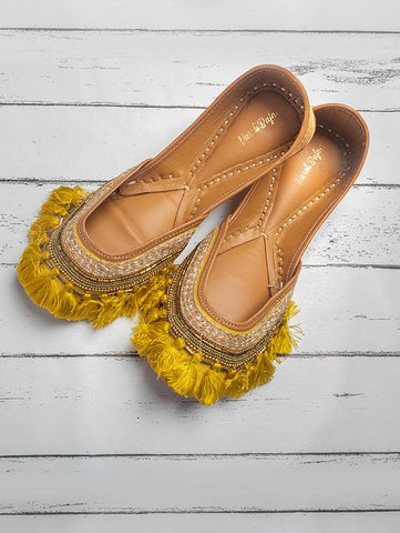 Yellow Tassel embellished juttis by Vareli Bafna now available at Trendroots