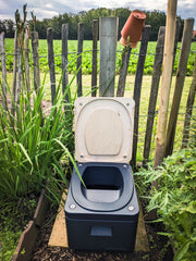 small composting toilet in garden