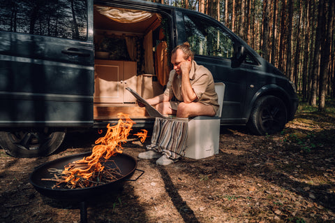 Person sitting on toilet by fire