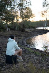 Man sitting on Trelino Origin by lake