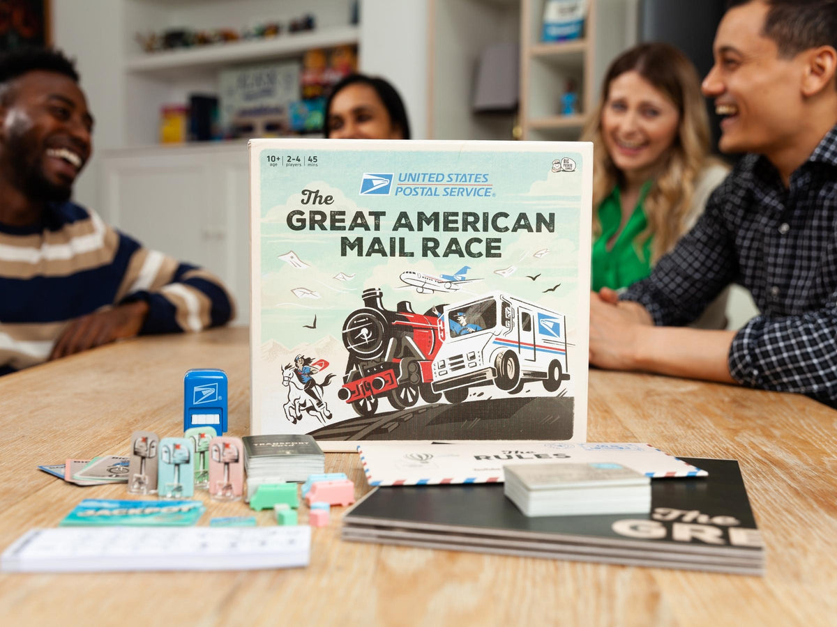 USPS Great American Mail Race box with contents and players on the background