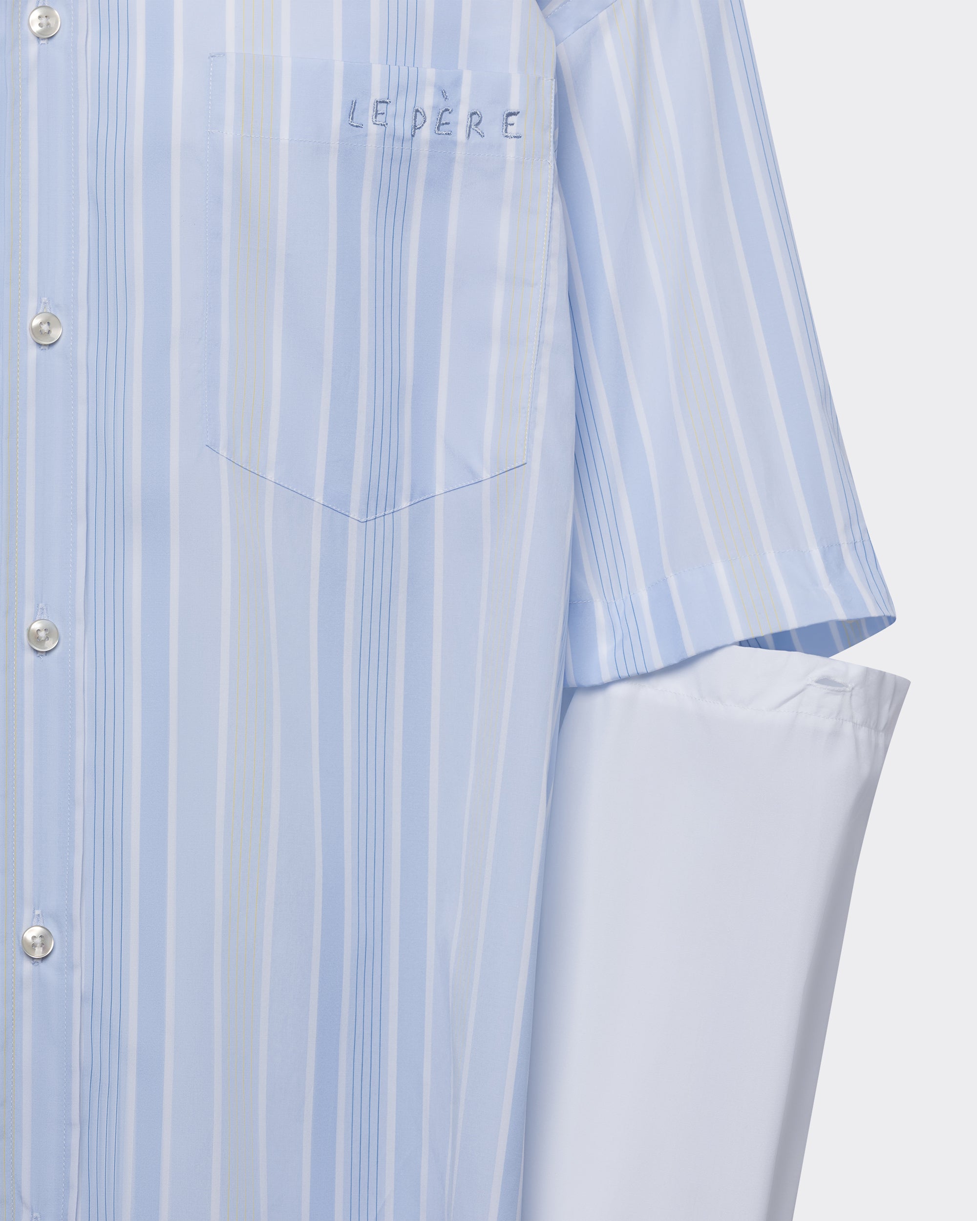 Close-up of the embroidered 'le PÈRE' logo on the chest pocket of the Blue Striped Detached Sleeve Button Down shirt.