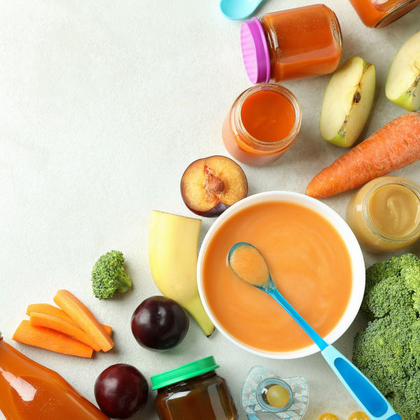 A baby food display with fresh fruits and veggies