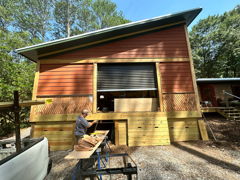 The shop getting the final exterior touches with a custom cedar shake install.