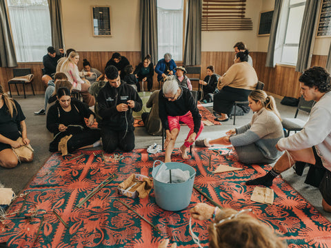 group of people sitting on mat learning maori birthing practices