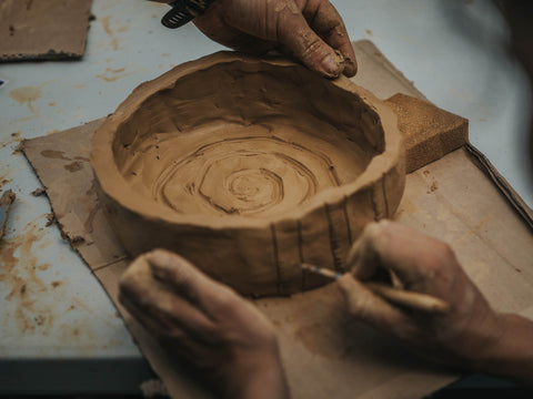 hands creating a maori ipu whenua for placenta burial