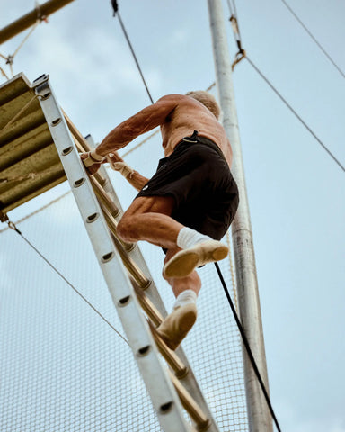 Mr. Moore climbs to start a trapeze trick. Credit...