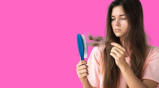 Woman with falling hair on her brush