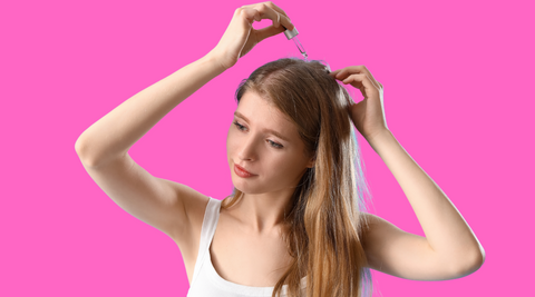 Woman with alopecia putting scalp treatment on her hair