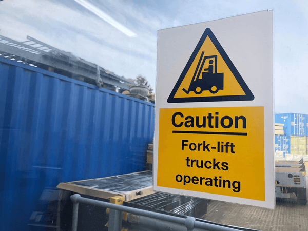 forklift sign with yard in background