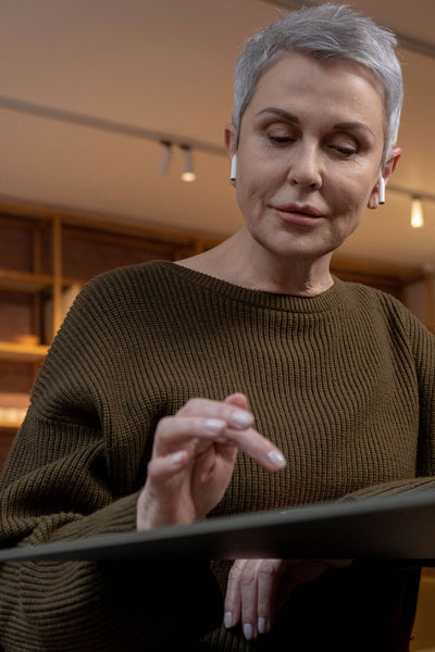 Woman With Short Gray Hair On iPad Gray Hair Styling Tips