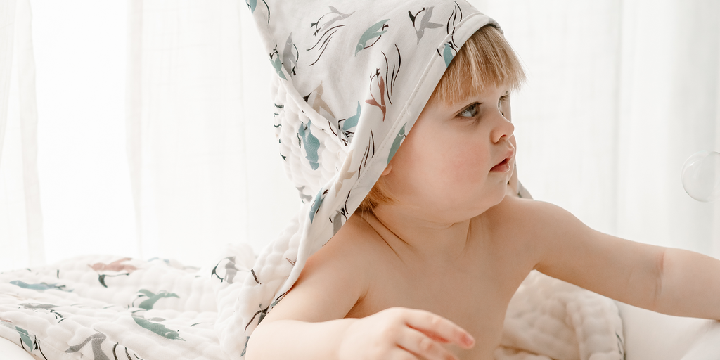 Baby wearing Nest Designs hooded bath towel