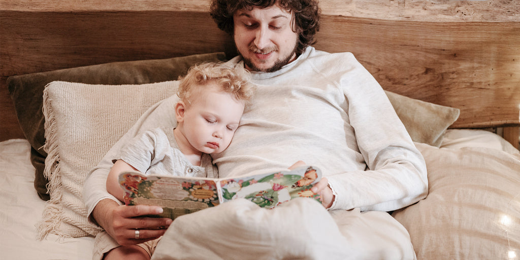 Father reading bedtime story to child