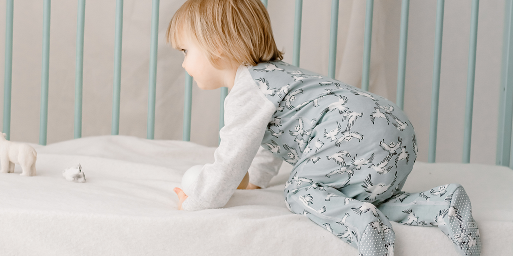 Baby wearing Nest Designs footed sleeper