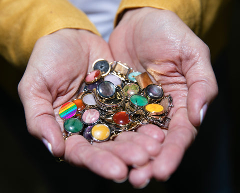 Image of person's hands holding various fidget rings and spinners