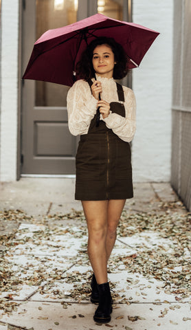 Girl with umbrella wearing fidget jewlery