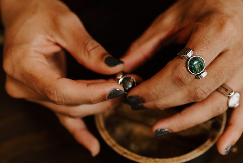 Person holding fidget ring and wearing Malachite fidget ring