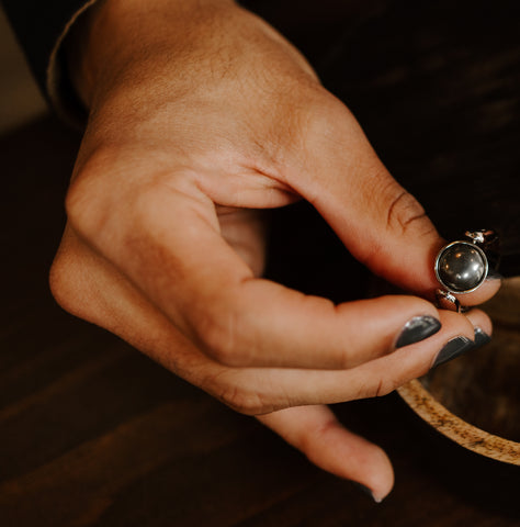 Person holding a Hematite fidget ring