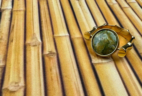 Rainforest Jasper Crystal Fidget Ring on a Bamboo Background