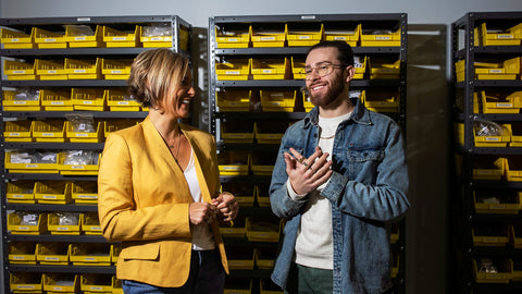 Tammy and Jake standing in the CONQUERing warehouse