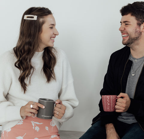 Two friends drinking coffee wearing fidget jewelry