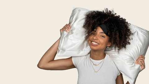 woman holding Bouclème's silk pillowcase