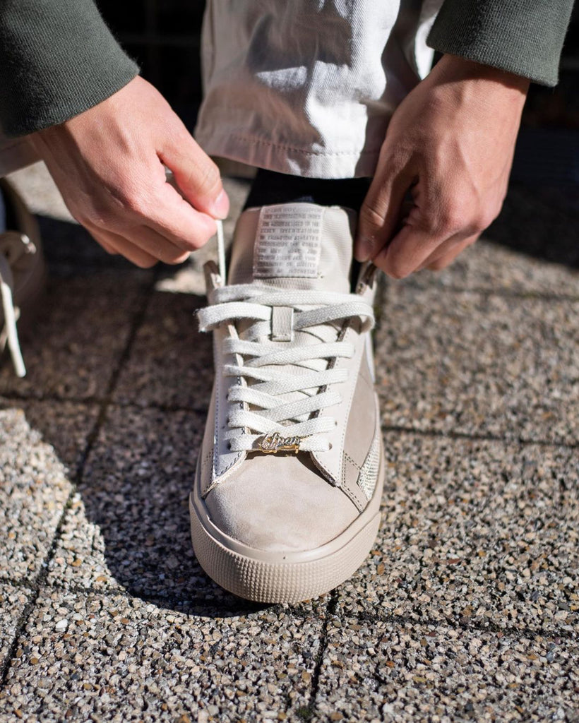 Person tying up shoe laces close up