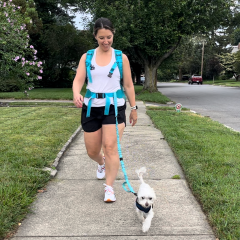 Woman walking with Jetti Pack and Jetti Dog Leash with small white dog