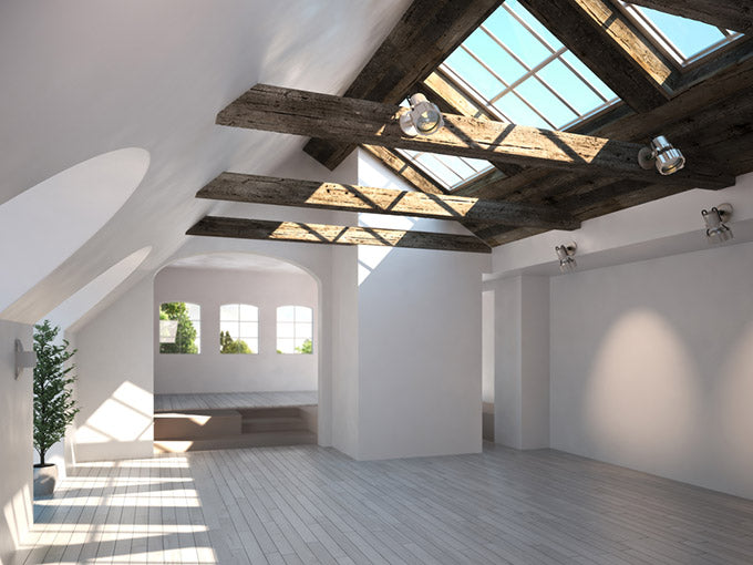 empty room with a rustic timber ceiling and skylights