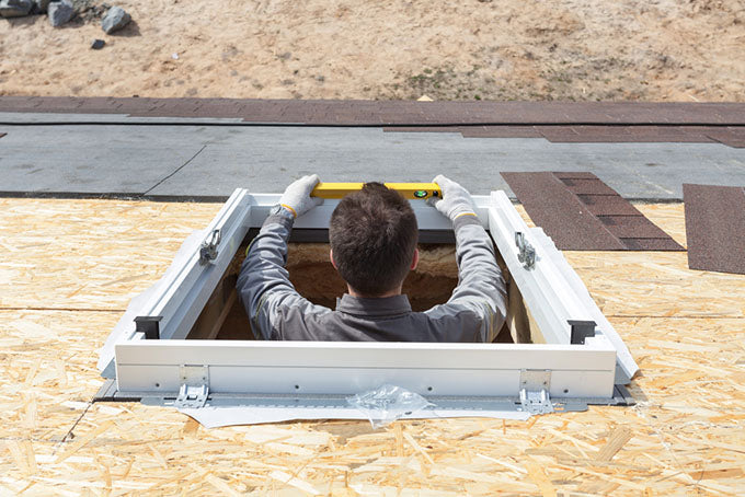 man installing a skylight