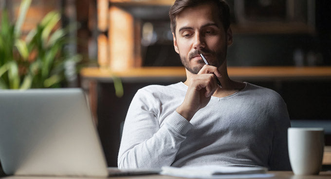 man sitting at a table thinking