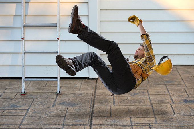 a worker with a hard hat falling