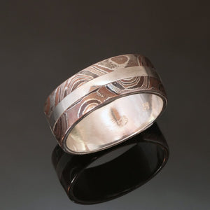 8mm wide Silver band with a centre stripe of Sterling silver and a band of mokume gane on the outside edges.