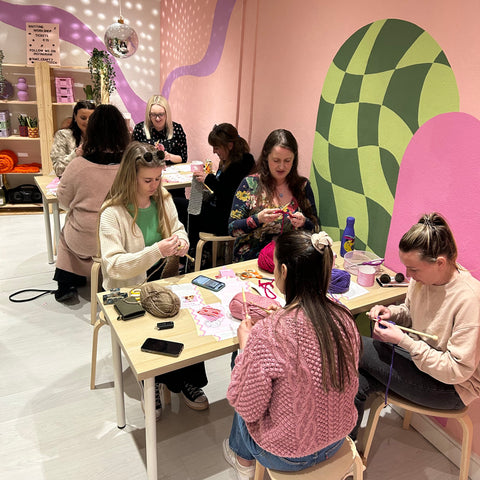 Group of girls learning how to knit