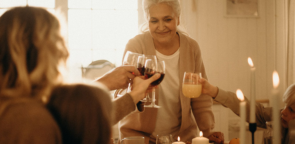 Family having meal at home cheering with wine glasses
