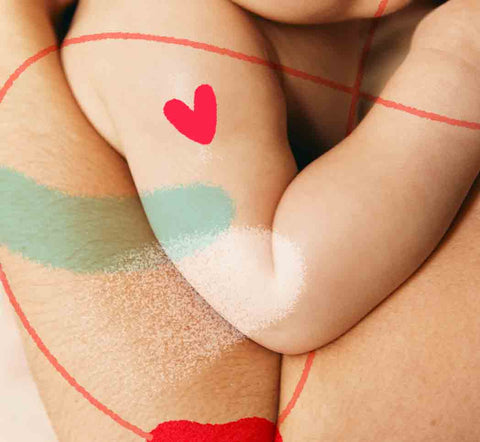 Una madre o un padre sujeta en sus brazos a su bebé, en contacto piel contra piel