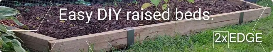 Photo of a mulched raised bed with borders made with 2xEDGE staples with text: Easy DIY raised beds.