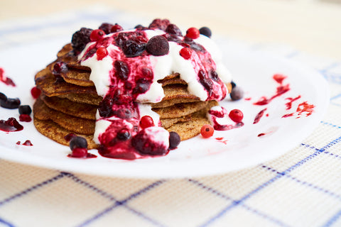 protein pancakes topped with natural yoghurt berry compote and fresh berries