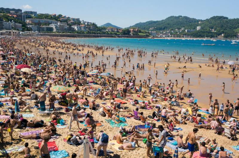 photo of a very crowded beach with lots of sun bathers