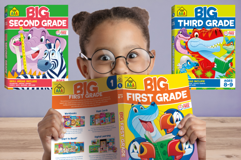 girl with glasses on looking over the top of a opened school zone big first grade workbook with the big second grade and third grade books displayed to the left and right of her head