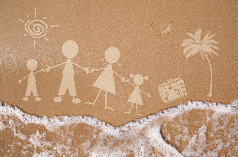 vacation image made from a photo of a sandy beach with water washing up and a simple drawing that looks like it is in the sand of sand of a family holding hands, with a suitcase, palm tree and sun