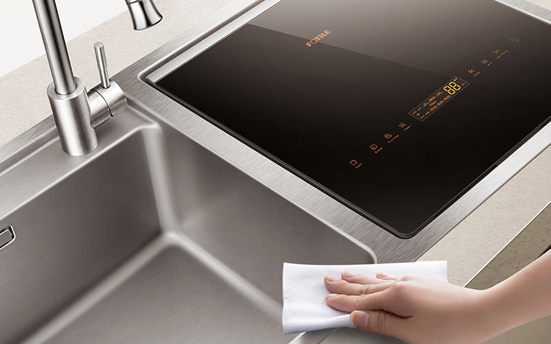 Person wiping down a stainless steel SD2F-P3 2-IN-1 In-Sink Dishwasher.