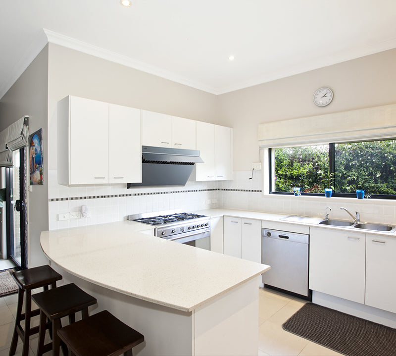 Stainless steel JQG01 range hood installed in a small white kitchen.