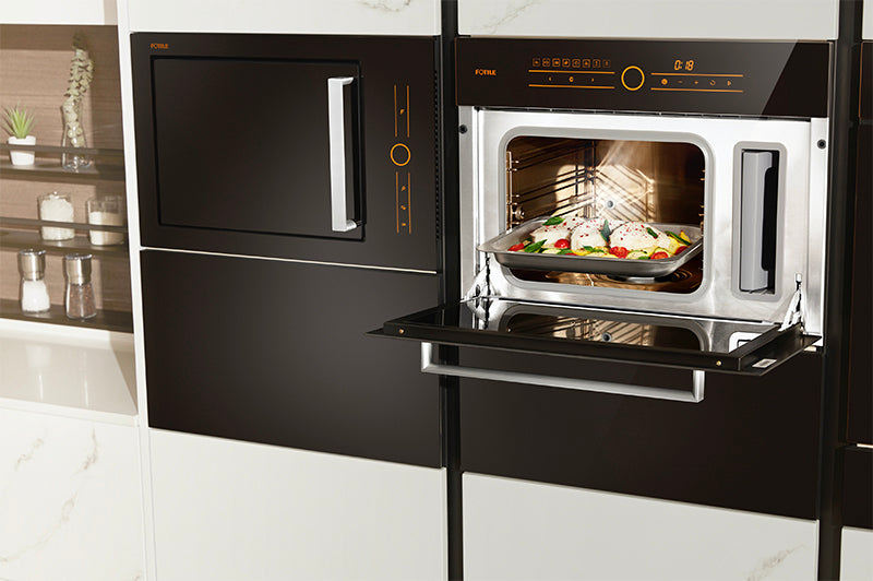 Wide view of a black SCD42-F1 steam oven in a modern kitchen with food inside the oven.