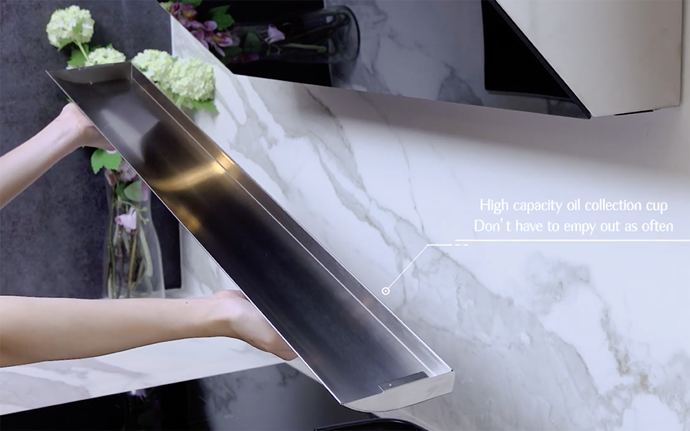 Person holding a grease collection cup for the JQG05 Series range hood.