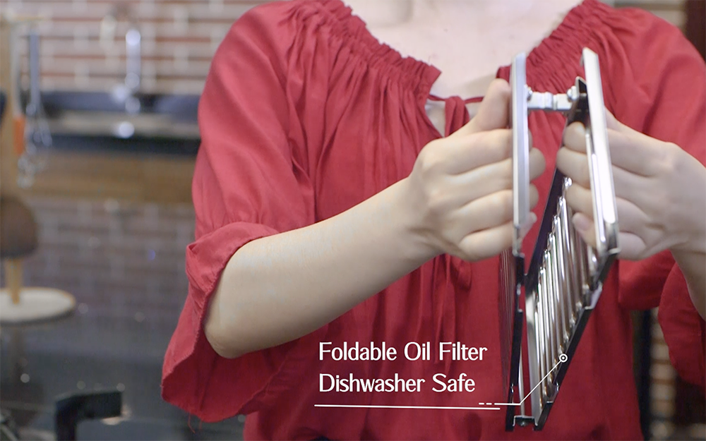 Person folding the dishwasher safe oil filter for the JQG02 Series.