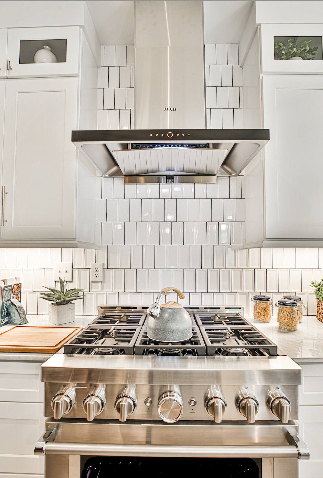 Man Cooking Food Below a FOTILE Range Hood