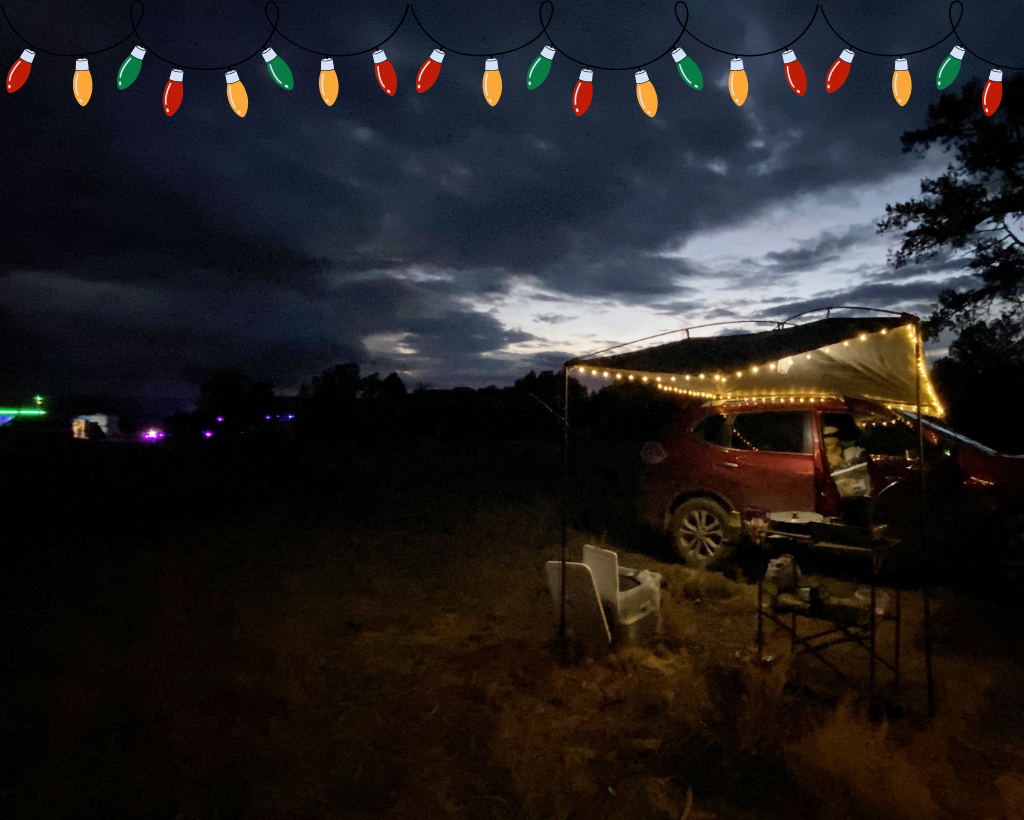 Nissan Rogue with MoonShade and string lights under a dark, twilight sky.