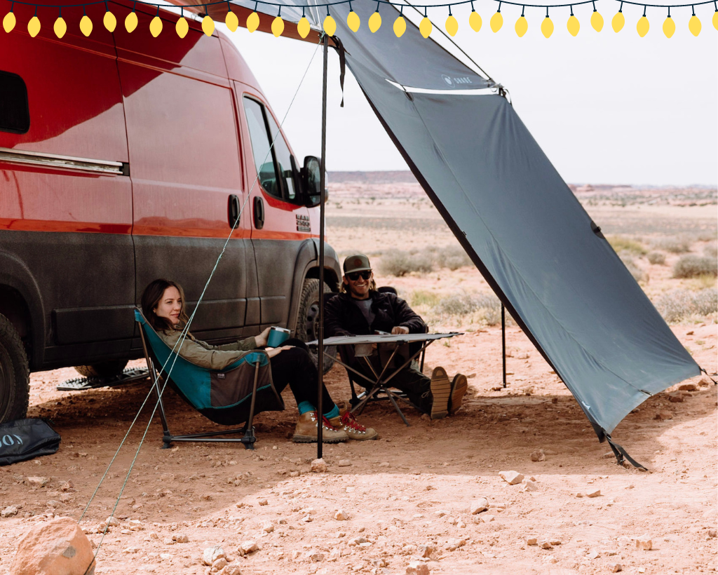 Red Ram ProMaster van with two people sitting under MoonShade and MoonWall