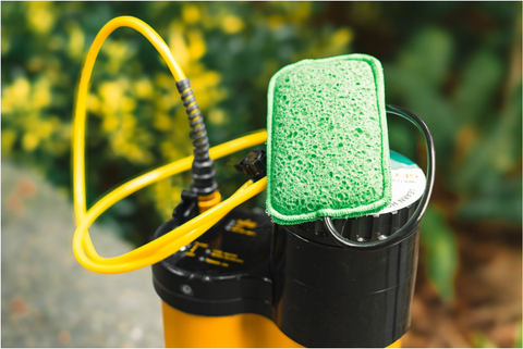 The Geyser System sits in a driveway, with its Green Sponge attached